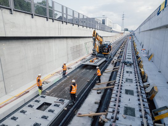 Several construction workers on a railway construction site in the city